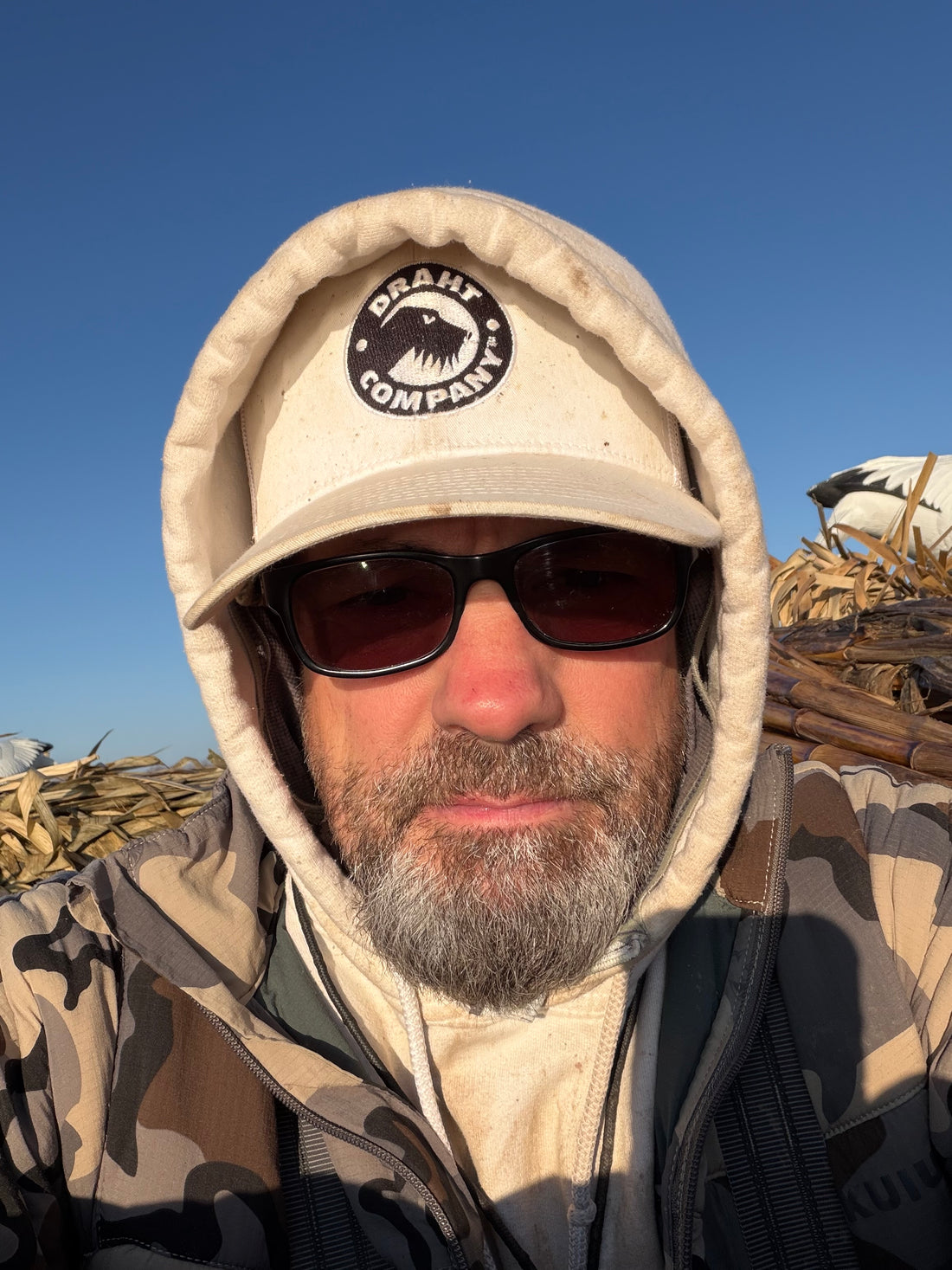 DRAHT CO Snow Goose Hat worn outdoors - white colorway blending into winter hunting environment