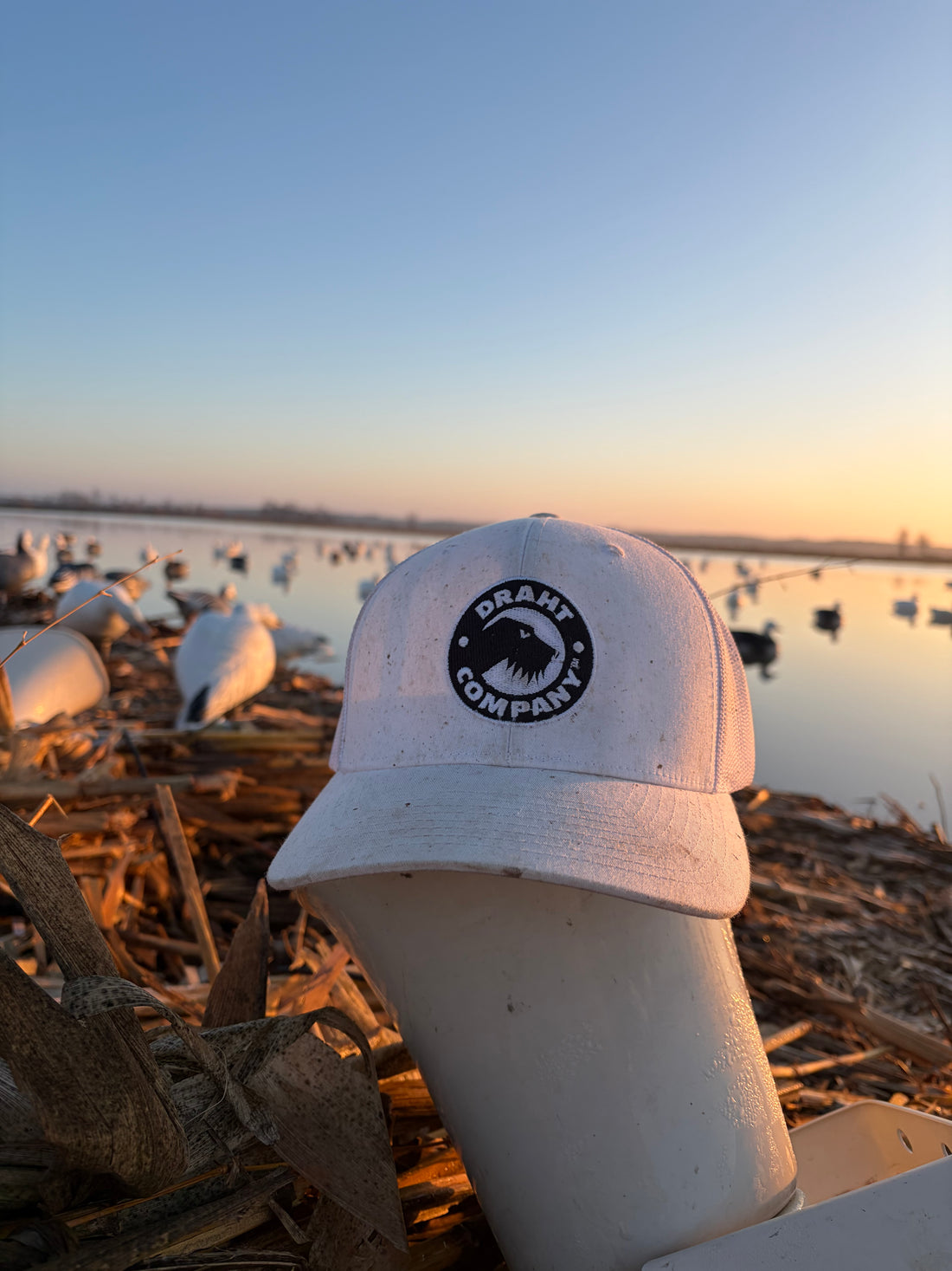 DRAHT CO Snow Goose Hat close-up of badge graphic - black and white snow goose design sitting on a snow goose e caller